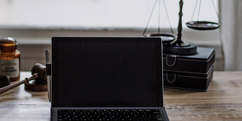 Desk with a laptop and balance scales